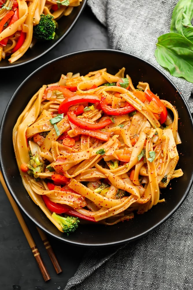 two bowls of noodles and veggies