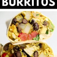 Close up of 3 breakfast burritos cut in half and stacked on each other
