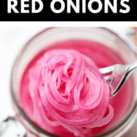 pinterest image of close up of a fork taking a scoop of pickled red onions out of a mason jar