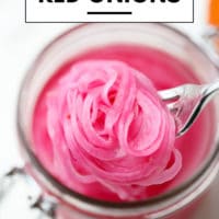 pinterest image of close up of a fork taking a scoop of pickled red onions out of a mason jar
