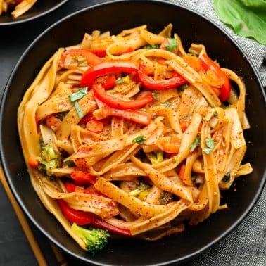 square photo of a bowl of noodles and veggies