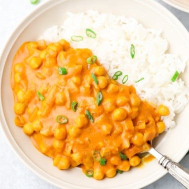 white bowl with chickpea tikka masala and white rice