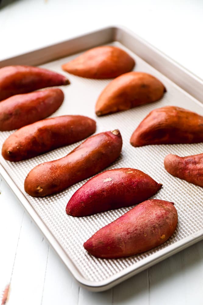 halved sweet potatoes on a baking sheet