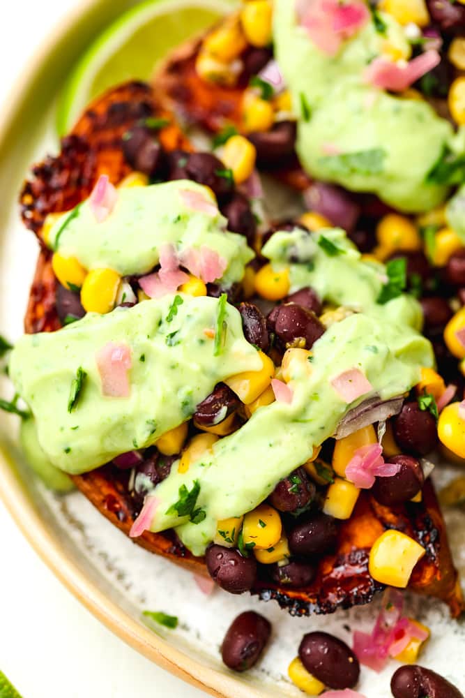 close up of a halved sweet potato stuffed with mexican fillings