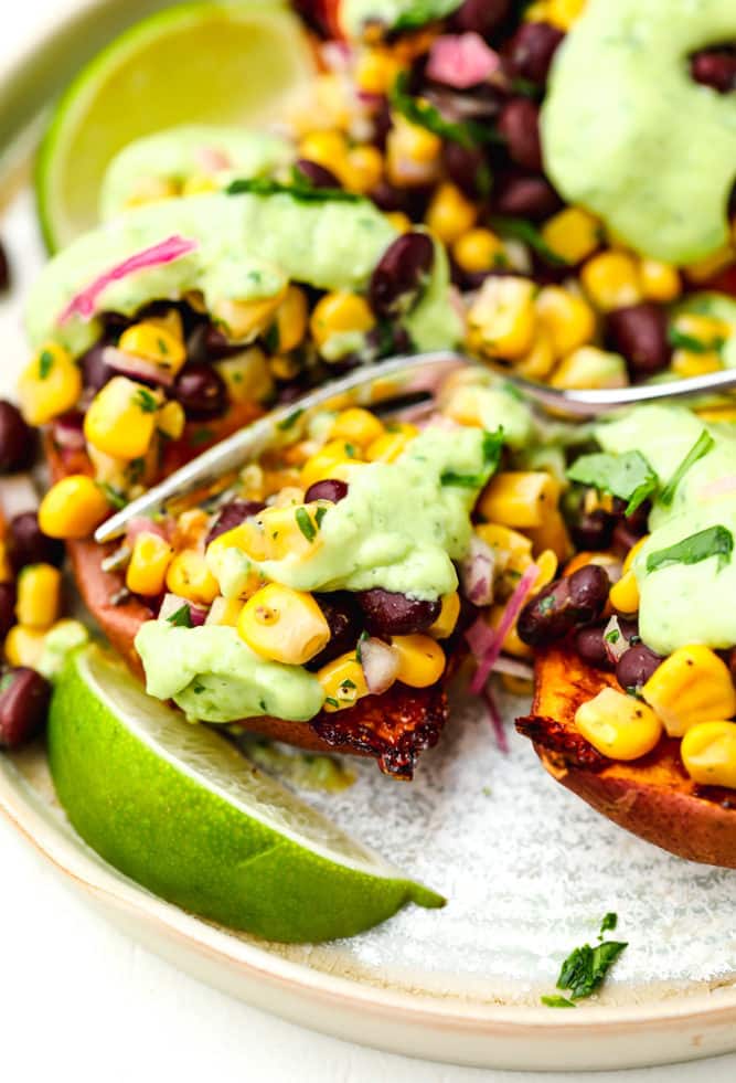 plate with 3 sweet potatoes and filling, limes on the side