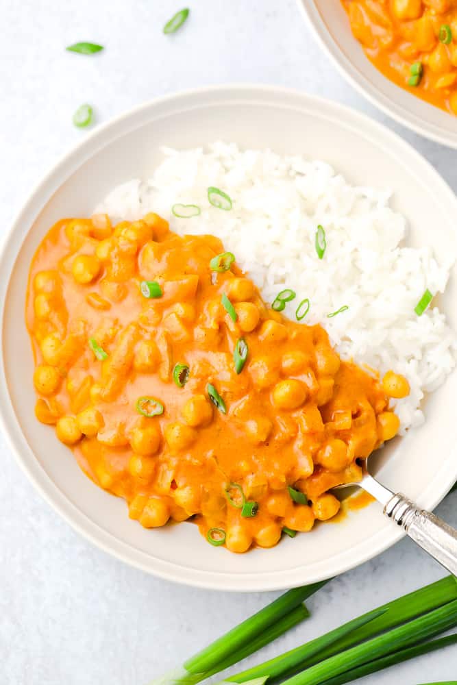 white bowl with bean tikka masala and white rice