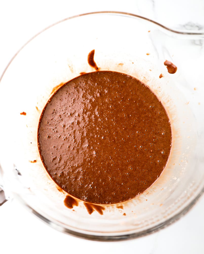 large glass bowl filled with chocolate cake batter