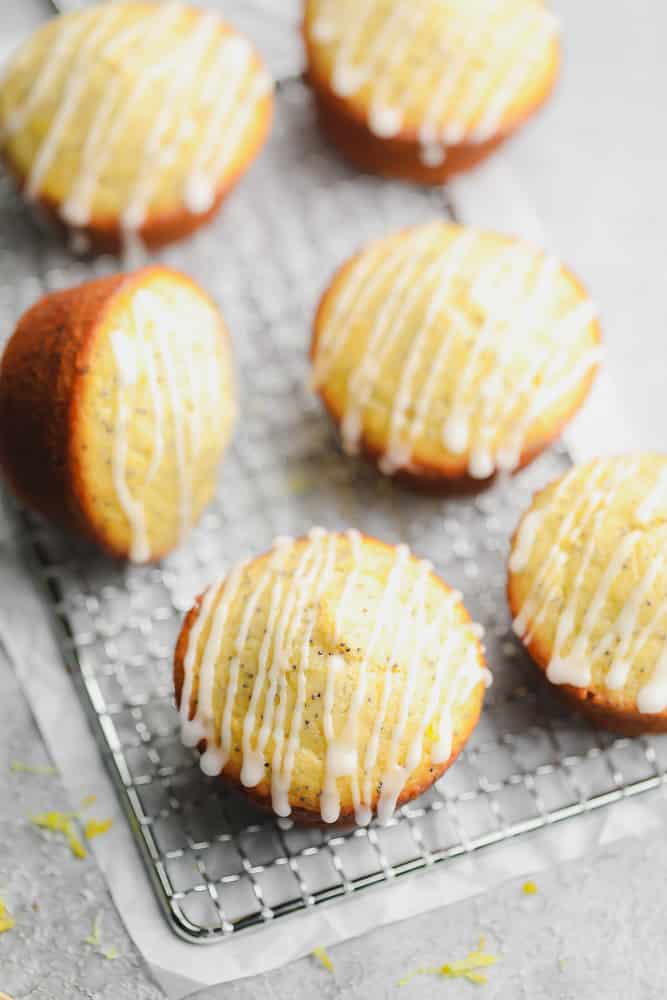 lemon muffins on a cooling rack with glaze