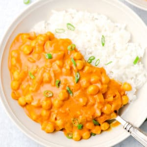 white bowl with chickpea tikka masala and white rice