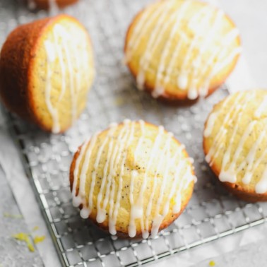 square image of lemon muffins with glaze on cooling rack