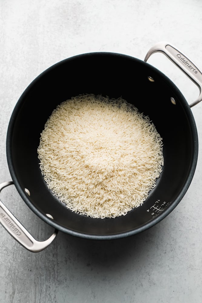 uncooked white rice in a black pot