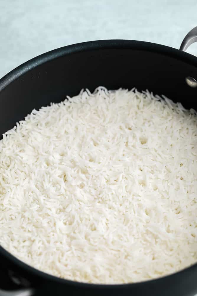 close up on a black pot filled with cooked white rice