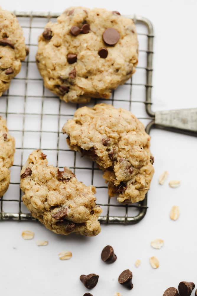 baked oatmeal chocolate chip cookie split in half on a cooling rack