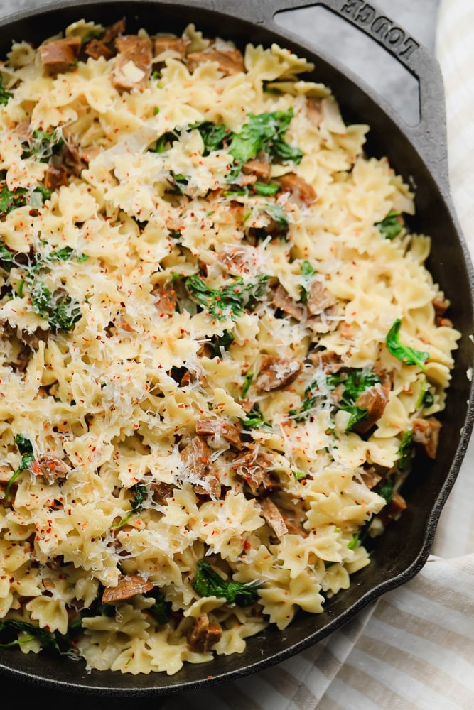 close up of vegan sausage pasta in black pan