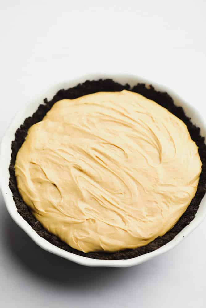 whole pie that looks creamy and brown in a oreo crust