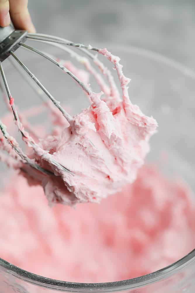 pink frosting on a whisk