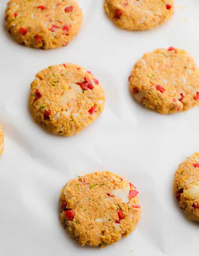 round orange vegan crab cakes on parchment paper