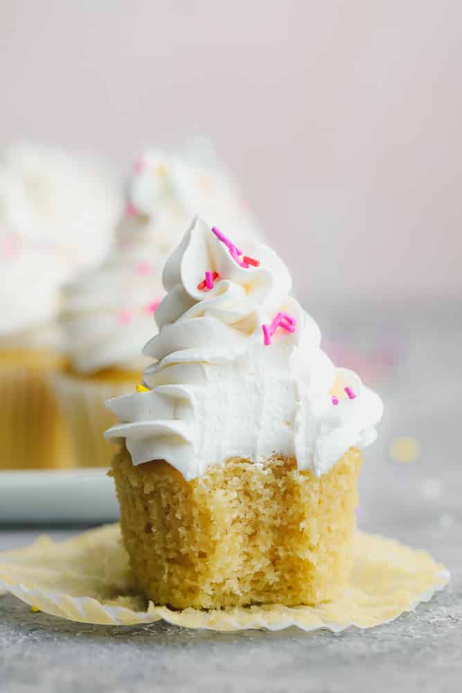 cupcake with a bite taken out of it, showing frosting texture