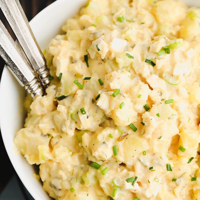 square image of vegan potato salad in a bowl