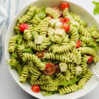 square image of a pesto pasta salad with tomatoes