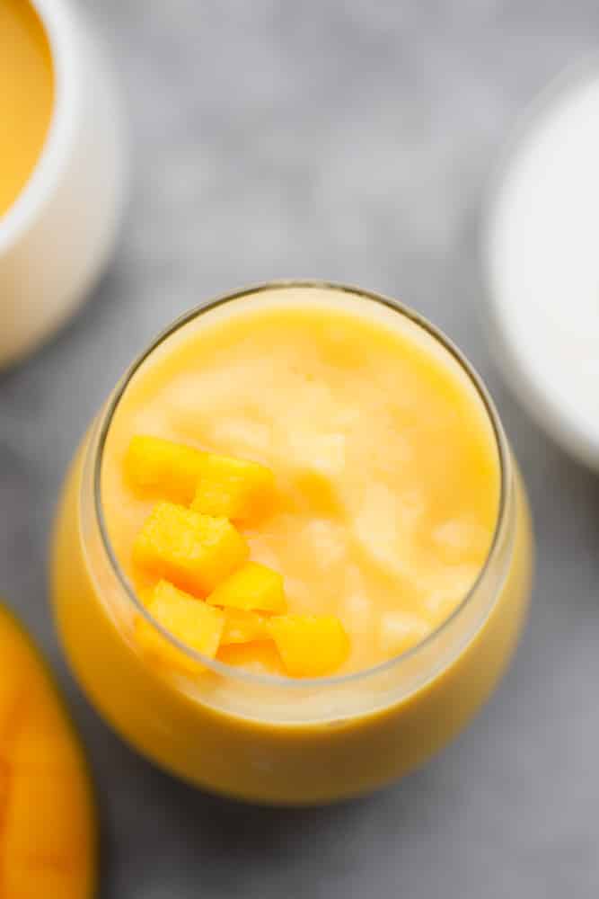 yellow mango smoothie in a glass