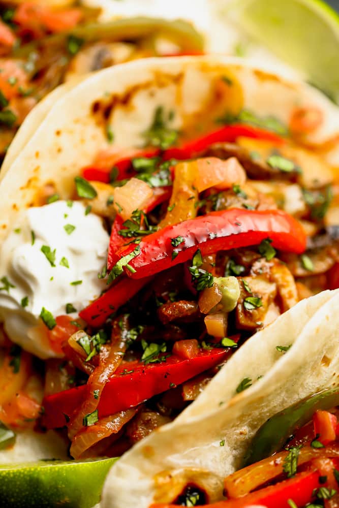 vegetarian fajitas in tortillas with sour cream