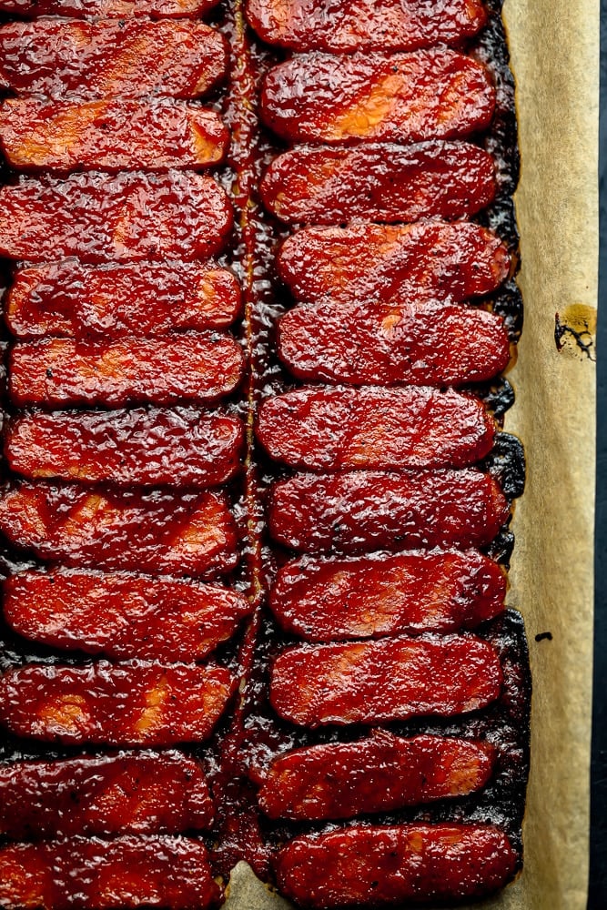 tempeh with bbq sauce cooked on a pan in a row