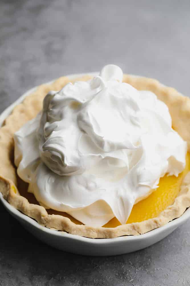 white meringue overtop lemon filling in a pie crust