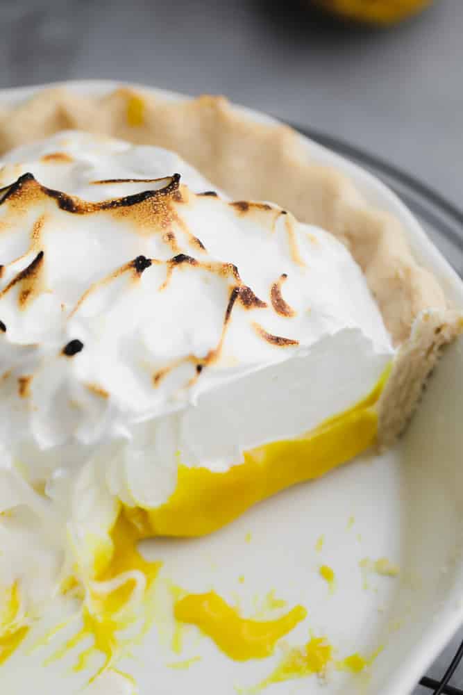close up on a lemon meringue pie with a slice removed