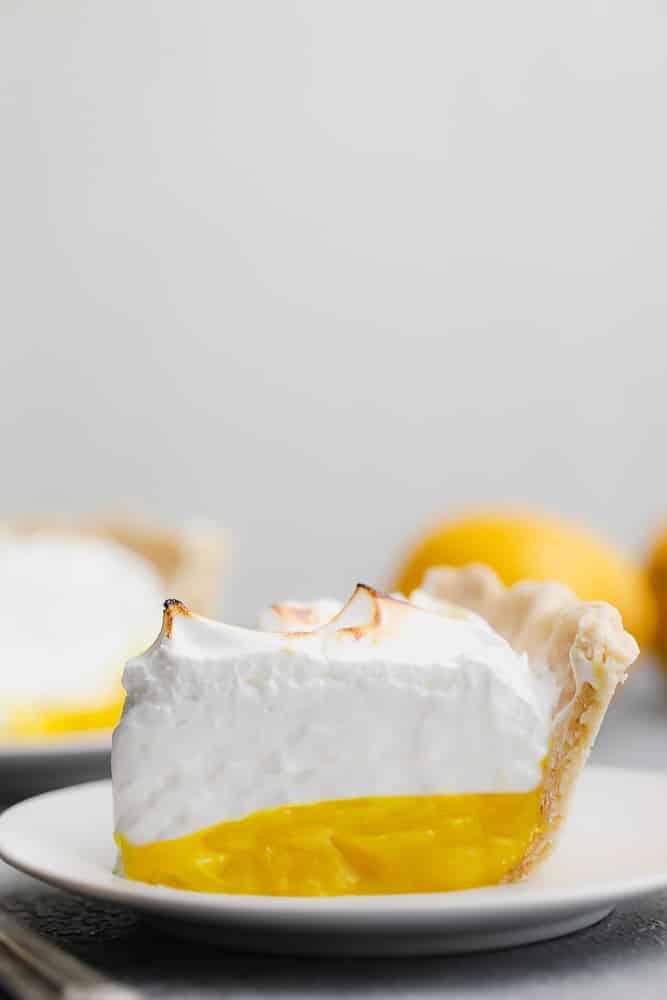 slice of lemon meringue pie on a white plate