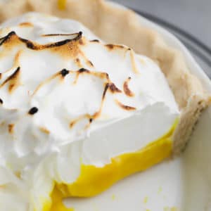 close up on a lemon meringue pie with a slice removed