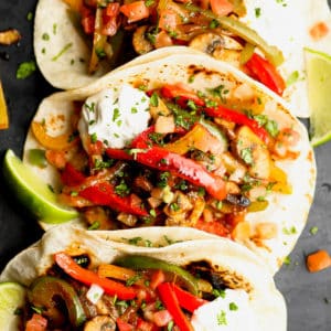 3 tortillas in a row stuffed with sauteed bell peppers, onions, and mushrooms