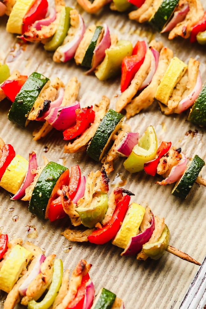 close up on cooked vegetable kebabs on a baking sheet