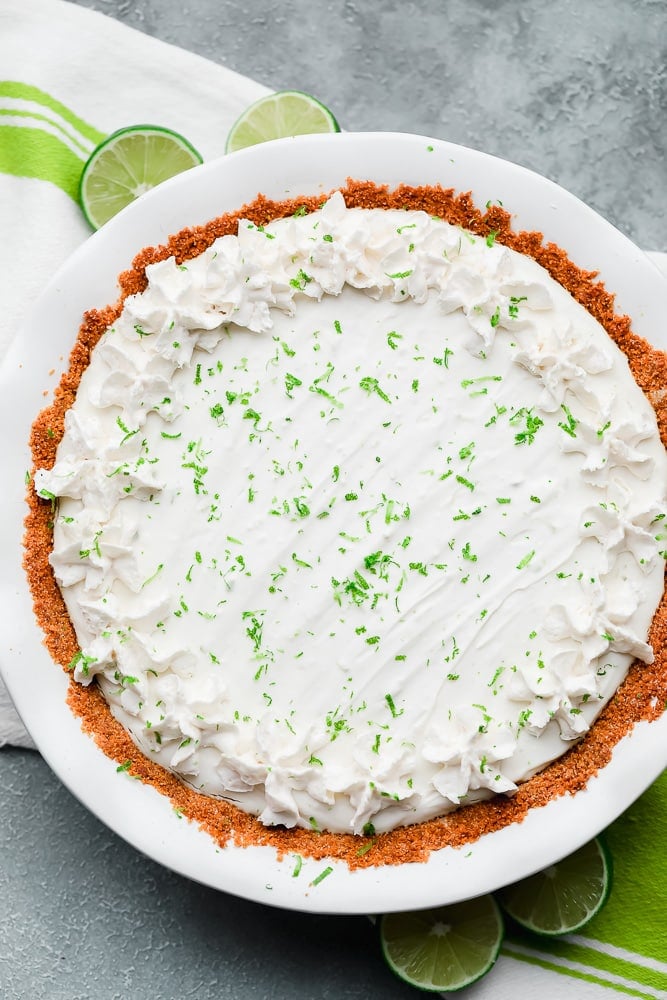 white key lime pie in a white pie plate