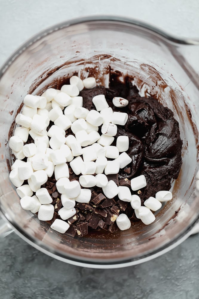 chocolate batter and marshmallows in a large white bowl