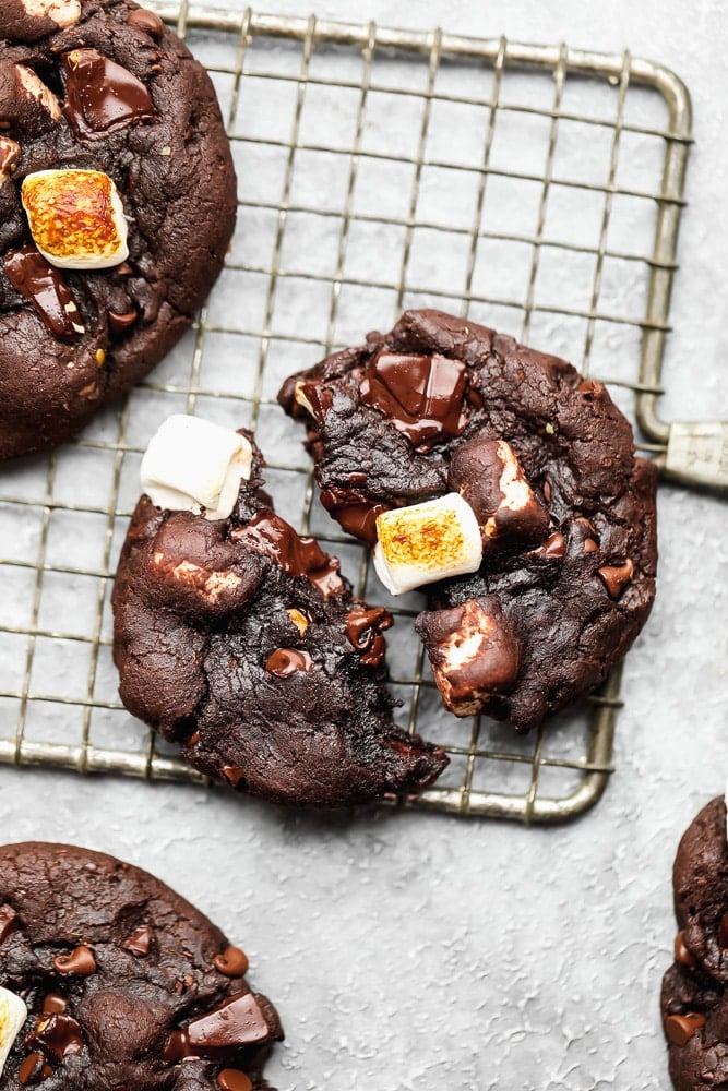 chocolate marshmallow cookie split in half on a wire cooling rack