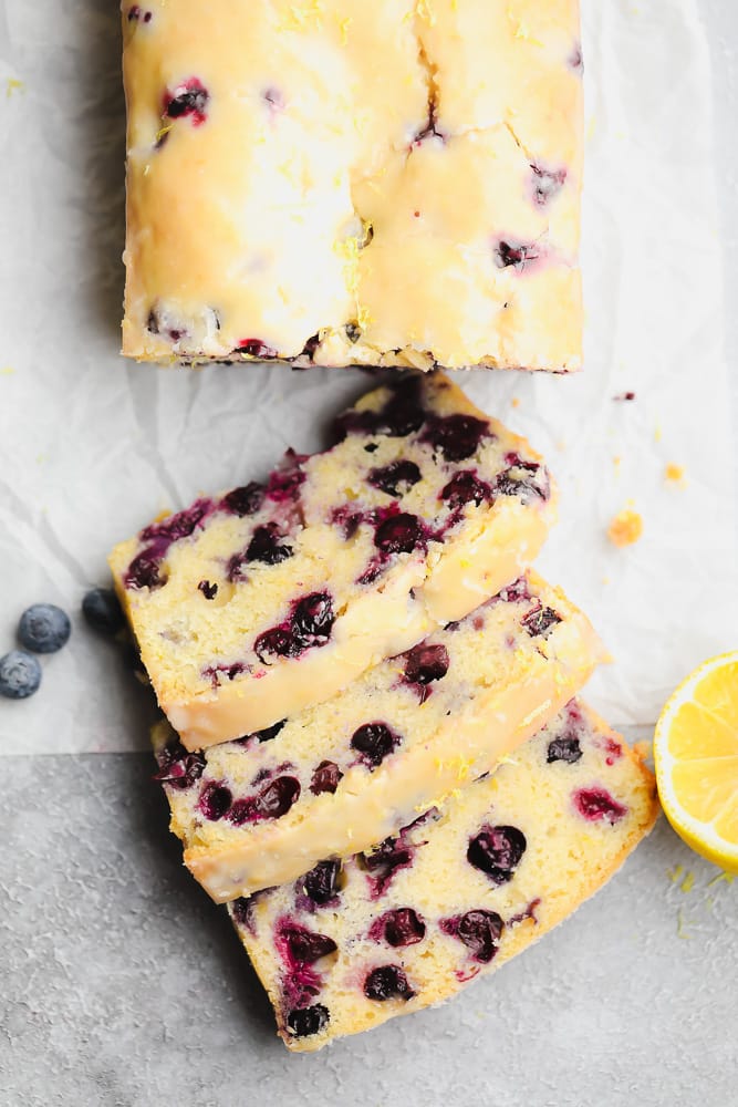 3 slices of blueberry and lemon bread next to the loaf