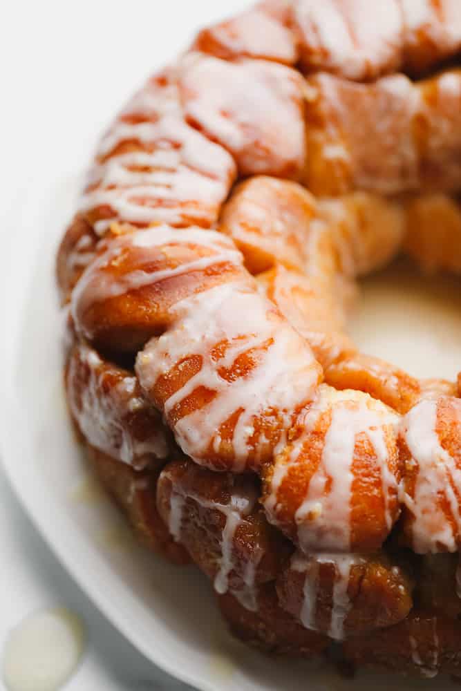 close up on a baked and glazed circle of golden brown monkey bread