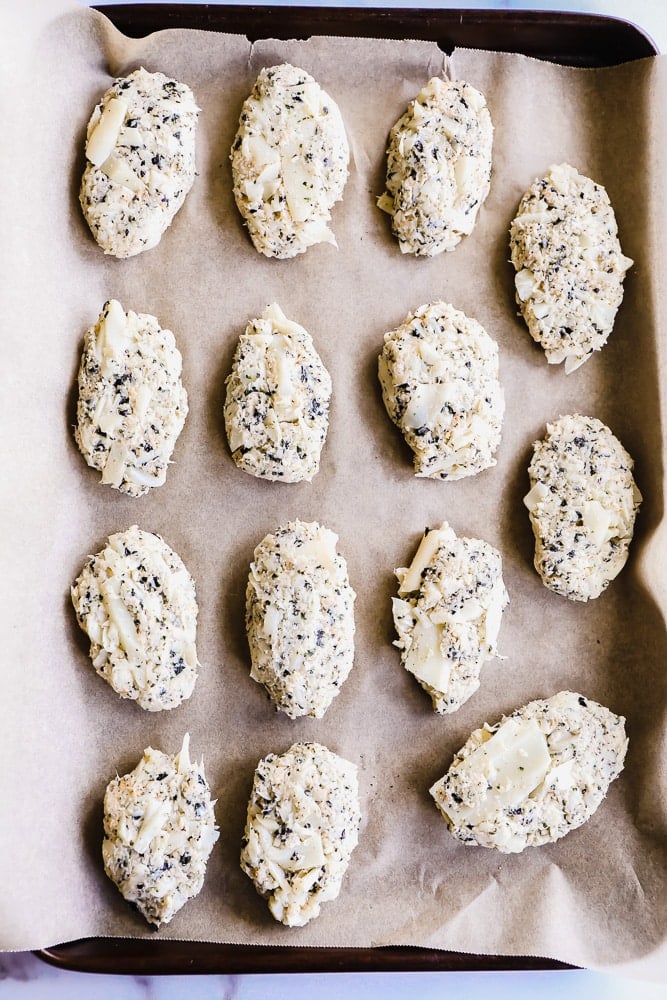 white vegan fish sticks on a parchment lined baking sheet