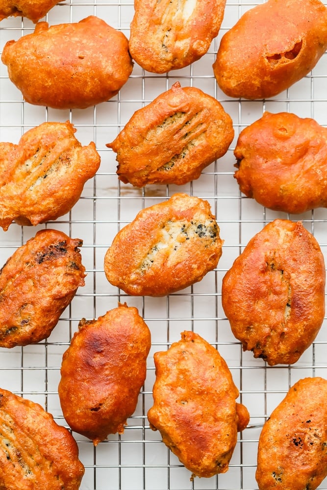 pieces of golden brown fried vegan fish on a wire rack