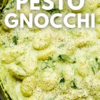 pinterest image of close up on creamy green gnocchi in a pot