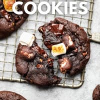 pinterest image of a chocolate marshmallow cookie split in half on a wire cooling rack