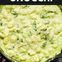 pinterest image of a large pot filled with a green cream sauce and gnocchi