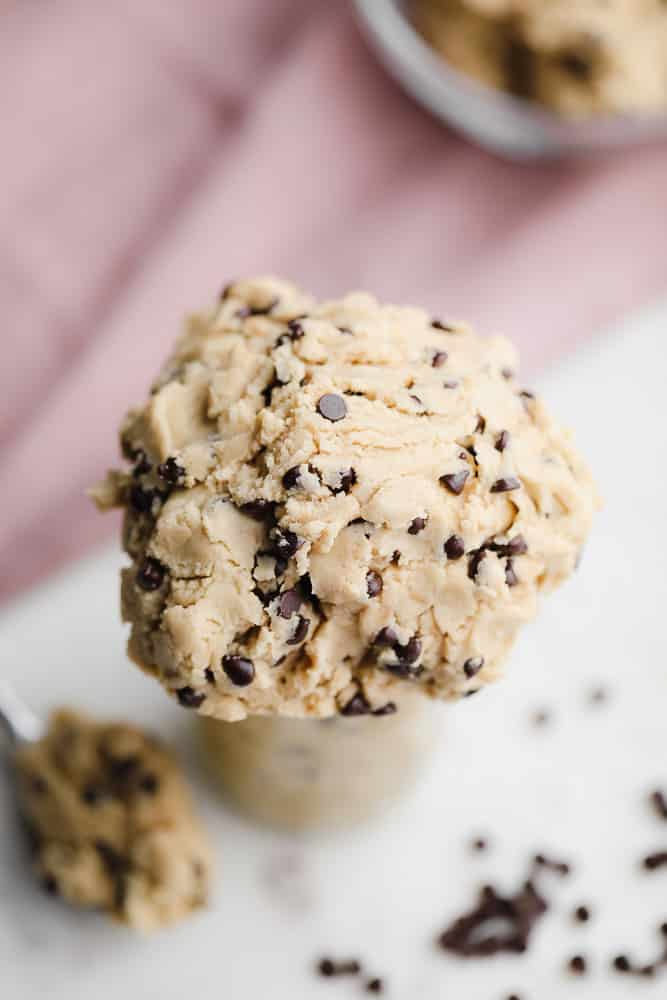 large scoop of chocolate chip cookie dough coming out of a jar