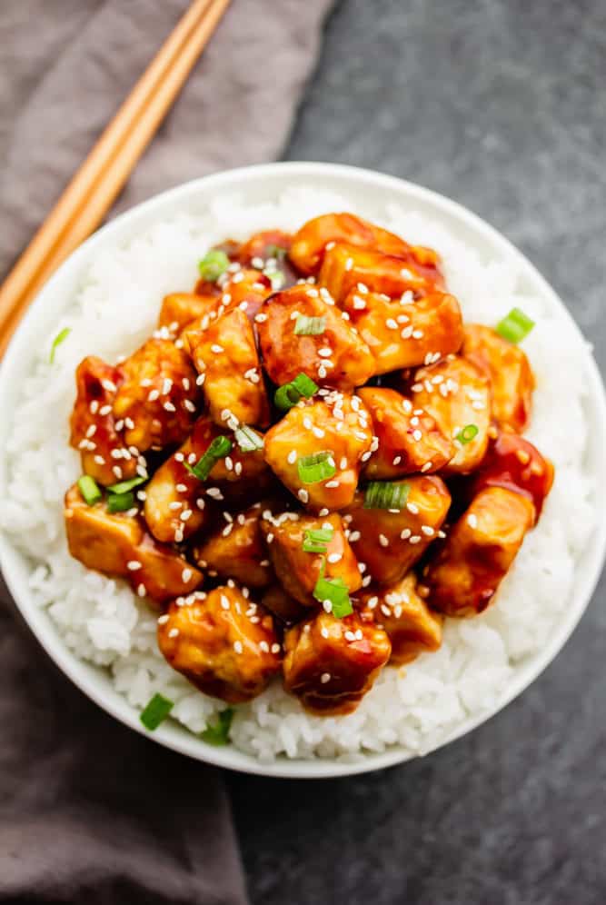 bowl with white rice and lots of general tso tofu in sauce