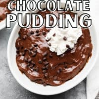 pinterest image of chocolate pudding in a white bowl topped with chocolate chips and whipped cream