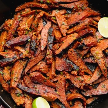 square image of carne asada made vegan in a black pan