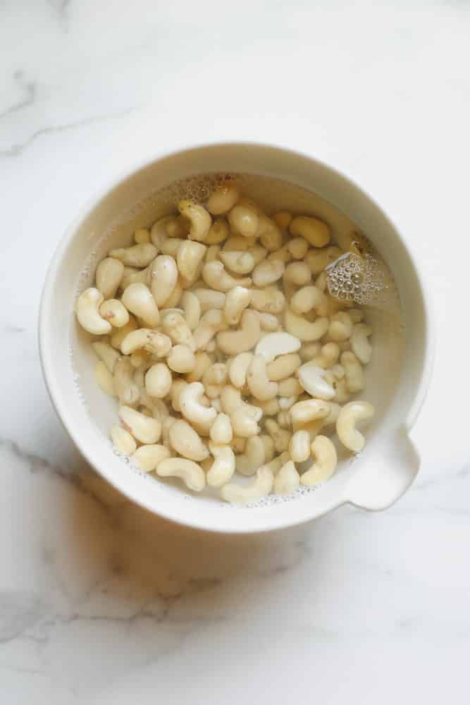 cashews covered in water in a bowl