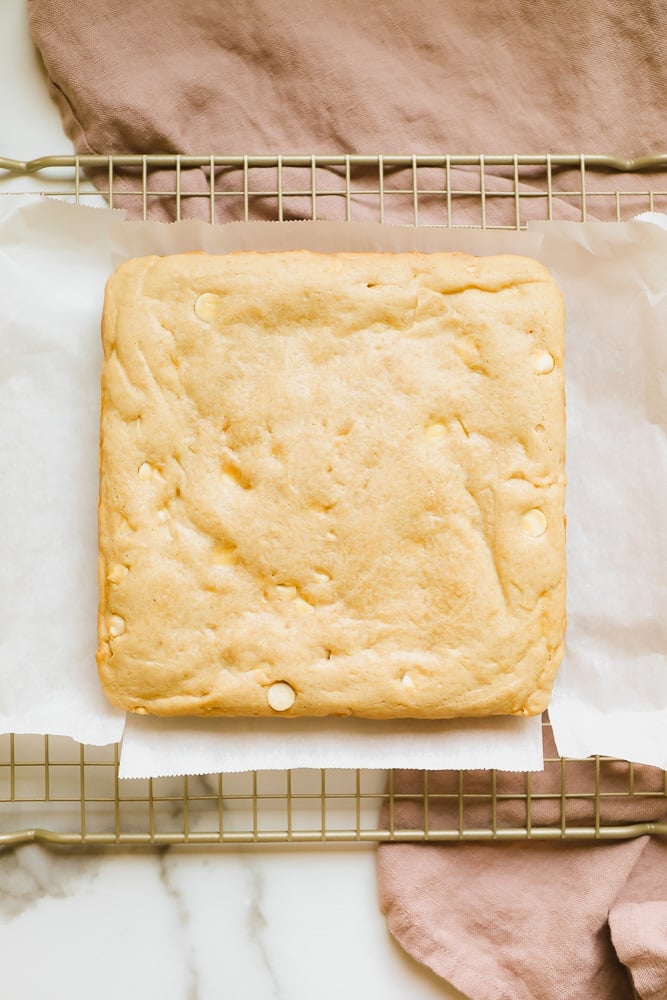 light brown baked blondies cooling on a wire rack