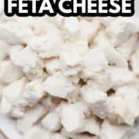 pinterest image of crumbled white cubes of vegan feta cheese on a white plate